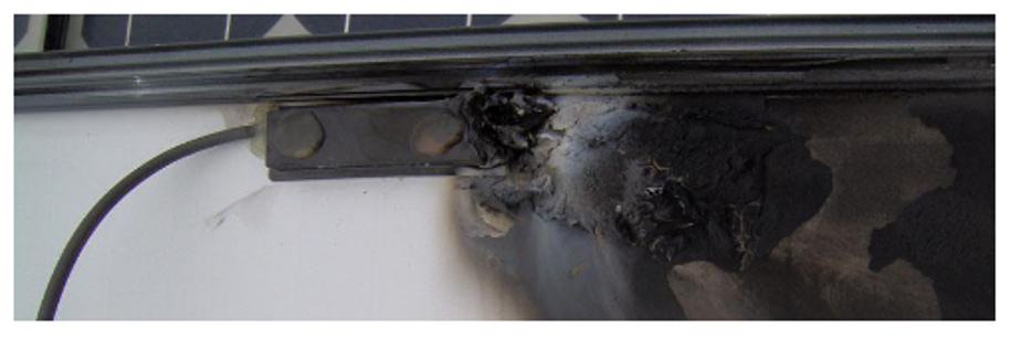 Figure 2: Burnt junction box caused by an arc at input lead [5]